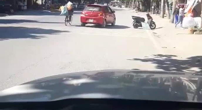 Chiếc xe ô tô đỏ dừng giữa đường mua đồ